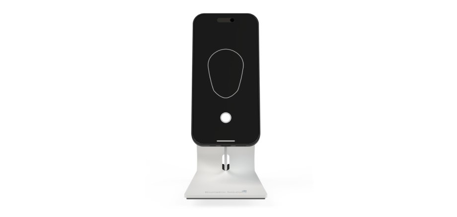 Kompaktes biometrisches Fotogerät in Smartphone-Form, montiert auf einer weißen Ladestation mit der Aufschrift „Biometric Solutions“.