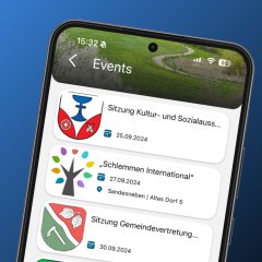 Smartphone zeigt in der FRED-App eine Liste an Veranstaltungen und Terminen aus der Region, darunter Sitzungen und Feste.