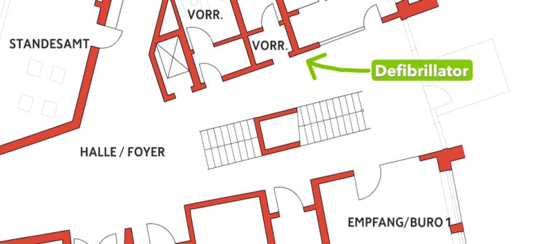 Ausschnitt des Grundrisses vom Foyer im Erdgeschoss des Regionalzentrums. Eine grüne Beschriftung mit Pfeil weist auf den Standort eines Defibrillators im Foyer neben den Toiletten hin.